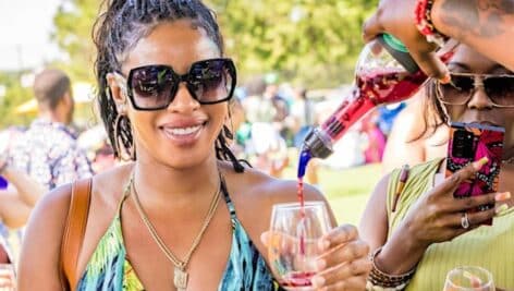 two women drinking wine outside