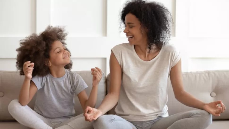a child and mother practicing yoga as self care.