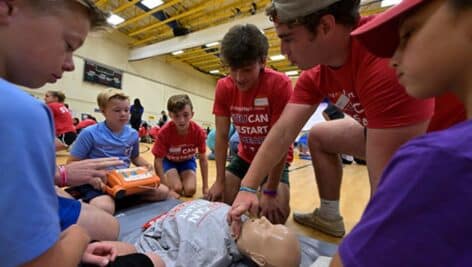 Children learning CPR.