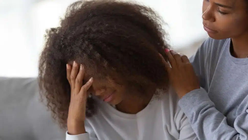 A counselor offers comfort to a teenager in distress.