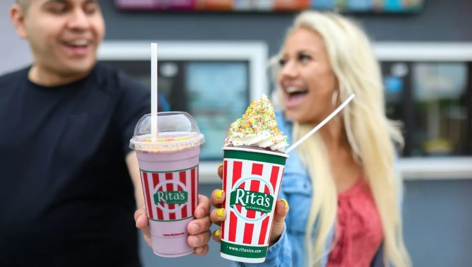 two people holding rita's water ice