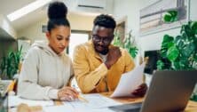 A young couple going over financial paperwork.