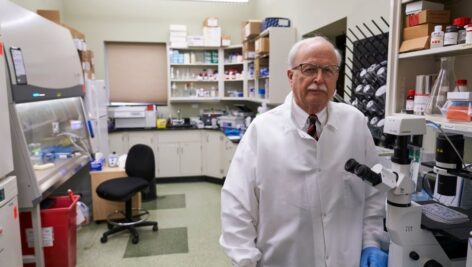 man in white coat in lab