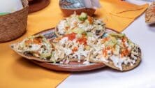 Mexican clay plate with tostadas and green lemons