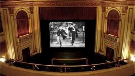 The Three Stooges in black and White playing at theater.