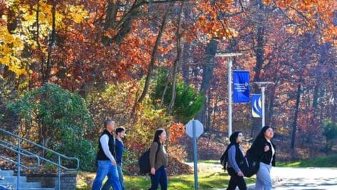 students walking on DCCC campus in the fall.