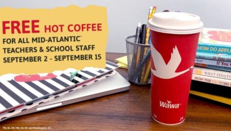 A Wawa coffee cup with some books and classroom supplies.