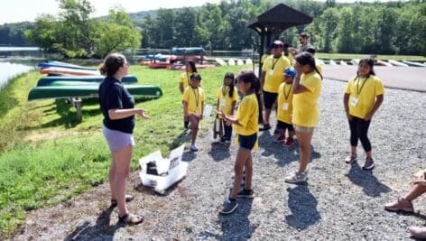 kids gathering with camp counselor