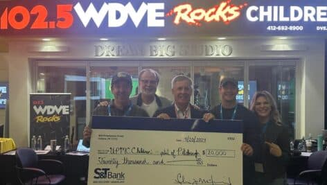 S&T Bank team members/leaders holding a large check for $20k for the WDVE iHeartMedia Pittsburgh fundraiser for UPMC Children's Hospital.