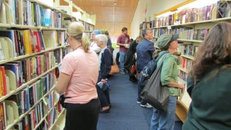 Attendees of a Chester County Library Book Sale exploring aisles.