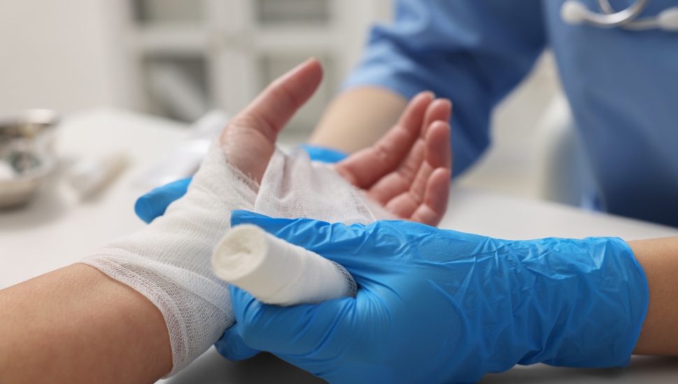 A patient getting hand wrapped at doctor's office.