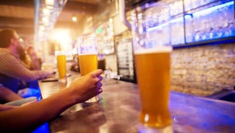 people drinking beer at sports bar to watch football