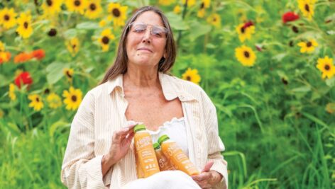 Francine Covelli holds bottles of Nourish Cold Pressed Juice.