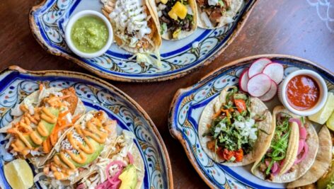 An array of tacos across several plates.