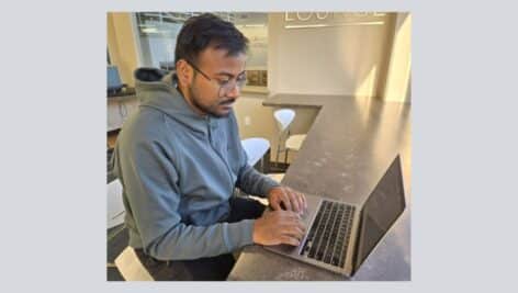 Anivesh Sinha, a grad student at Penn State Great Valley, does work on his laptop.