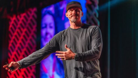 Mick Ebeling on stage at VFTCB's Annual Lunch delivering a keynote speech on the theme, "Possible."