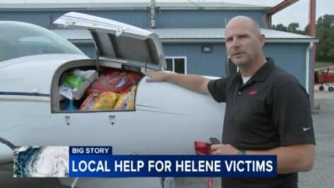 Jonathan Martin, director of aviation for New Garden Flying Field shows where supplies are stored on aircraft providing relief to North Carolina victims.