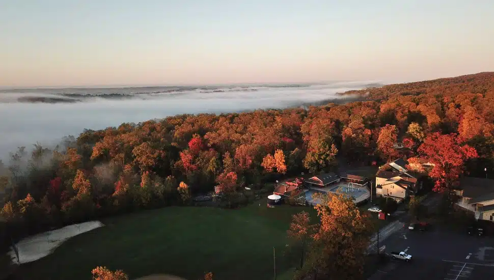 An aerial view of Refreshing Mountain in Lancaster County. The landscape is filled with colorful fall trees and the woodland expanse.