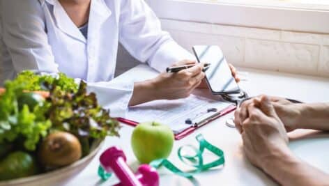 Nutritionist giving consultation to patient with healthy fruit and vegetable, Right nutrition and diet concept