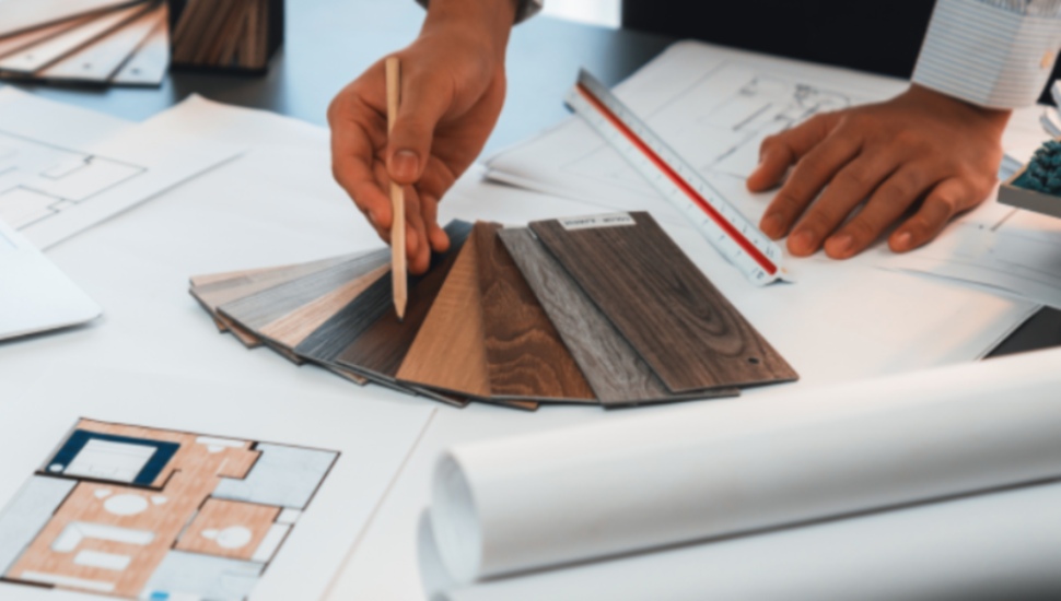 An interior architect designer at a workstation chooses mood board samples.