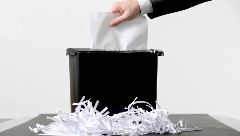 person shredding paper.