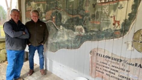 two men from Working Together nonprofit stand at Fellowship Farm