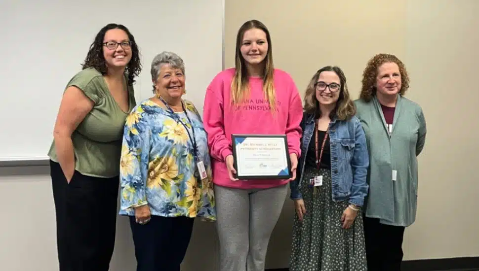 Mia Fragale holds her scholarship award. With her are (from left) KaSaundra Willis Nikola Freeland, Jessica Amarant, and Diane Berman.