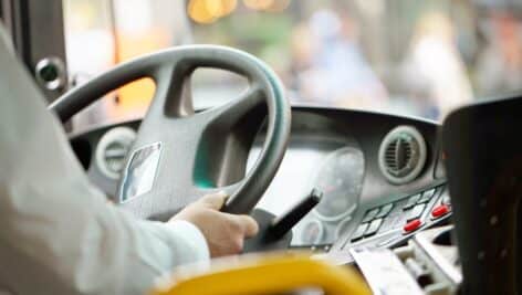 bus driver holding steering wheel