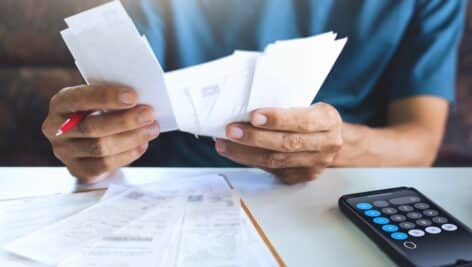 stressed person using calculator for high tax bills