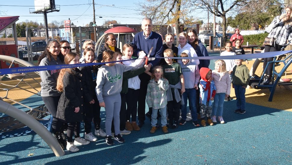 Enthusiastic kids are ready to play as a ribbon is cut opening an improved playground at the Fox Chase Recreation Center.