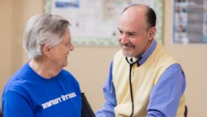 A doctor talks with a Dunwoody Village resident wearing a “Dunwoody Strong” shirt.