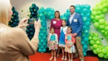 family poses for photo at awards ceremony