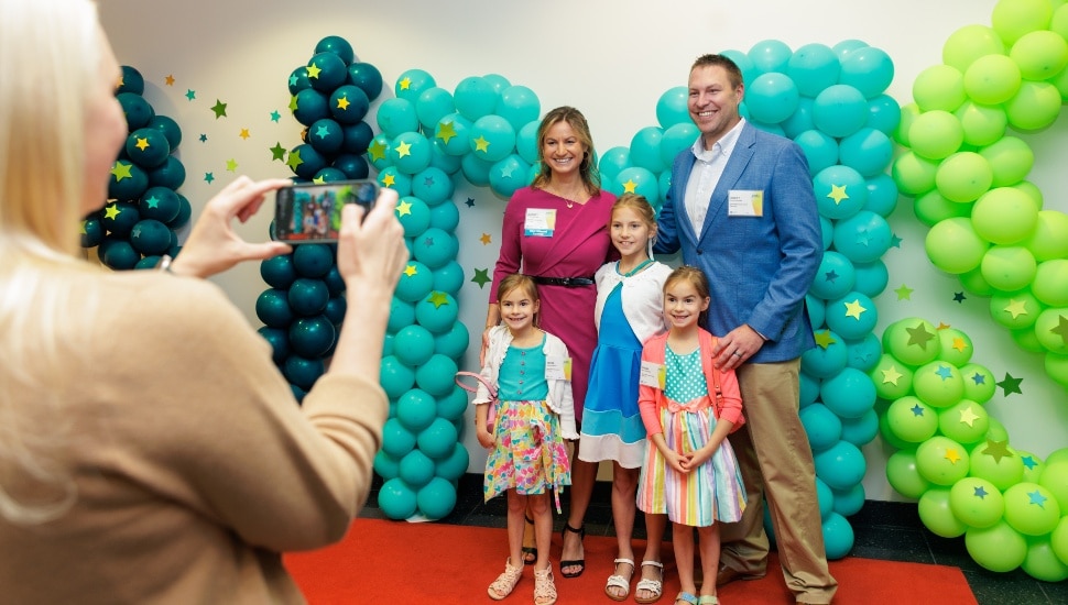 family poses for photo at awards ceremony