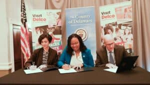 Dr. Marta Yera Cronin, President, Delaware County Community College; Dr. Monica Taylor, Chair, Delaware County Council and Steve Byrne, Executive Director, Visit Delco, sign the partnership agreement.