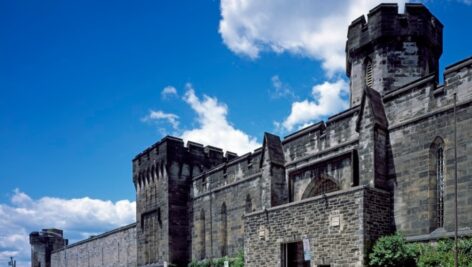 Outside of Eastern State Penitentiary with blue sky in background.