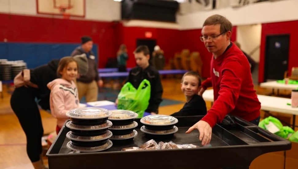 People filling food on trays.