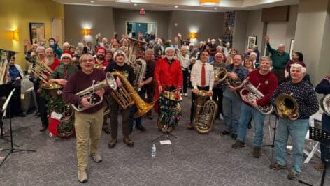 Musicians play Christmas music at senior living facility.