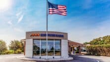 Bank building exterior with American flag.