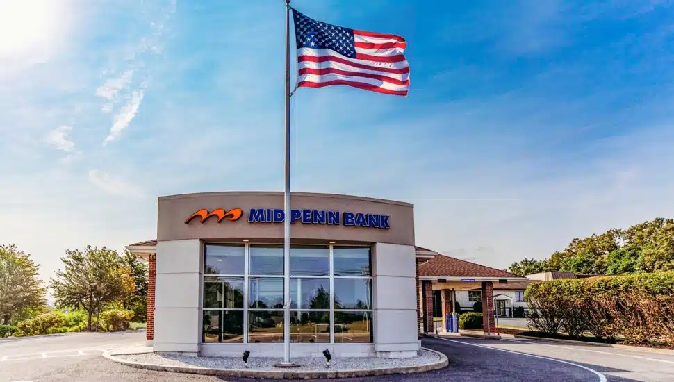 Bank building exterior with American flag.