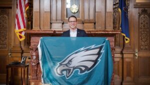 Josh Shapiro holds Eagles flag.