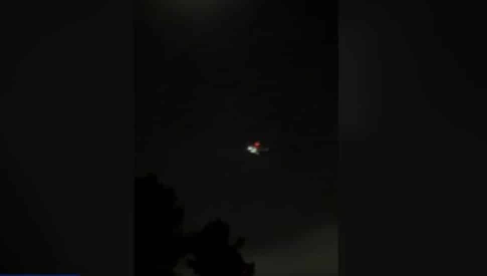 Drone in dark night sky.