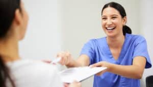 Shot of a patient and nurse assistant interacting.