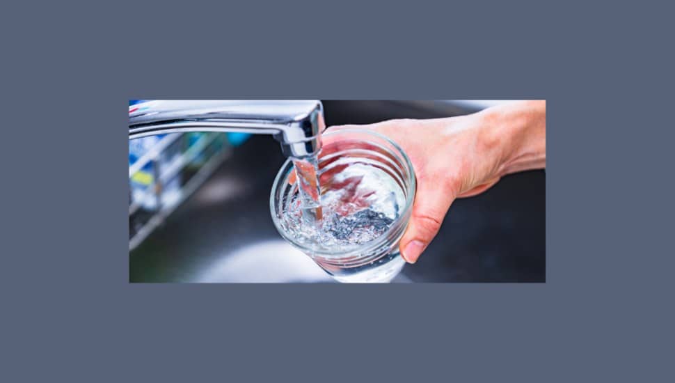Clean, safe drinking water being poured into a clear glass.