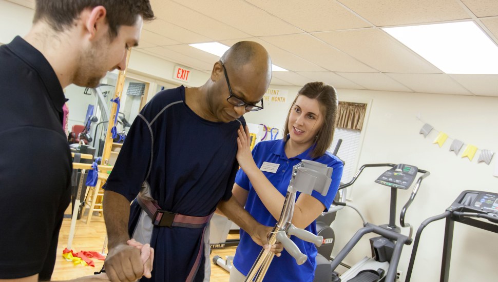 William Beachem (center) receives physical therapy from student-clinicians at the Chester Community Clinic.