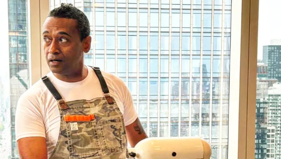 Chris Scott cooking in kitchen.