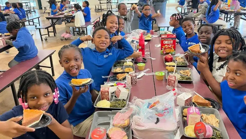 Young students eat lunch in a school cafeteria.