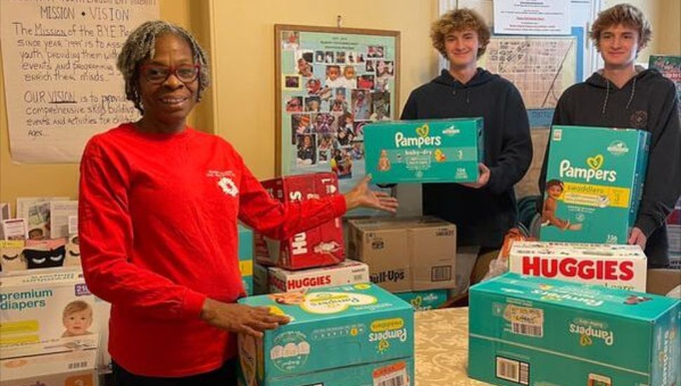 Jack and Red Thomas with another woman and a bunch of boxes of diapers.