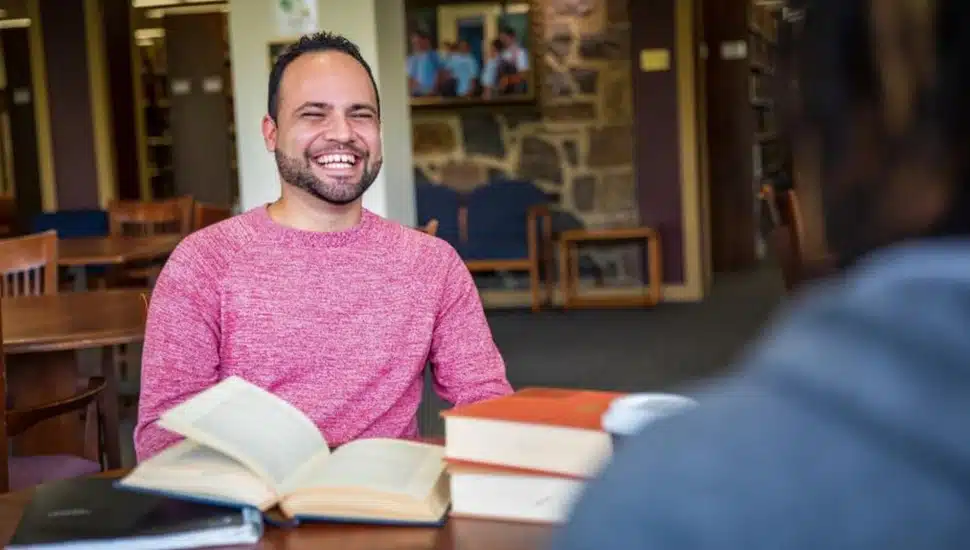College student smiles while studying.