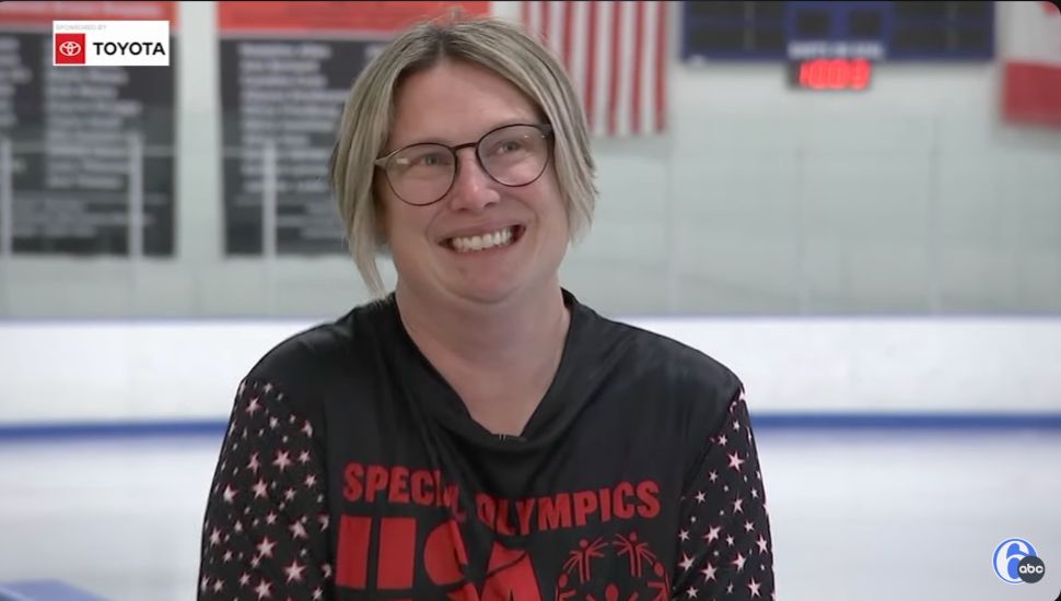 Lisa Robinson smiling with the ice rink in background.