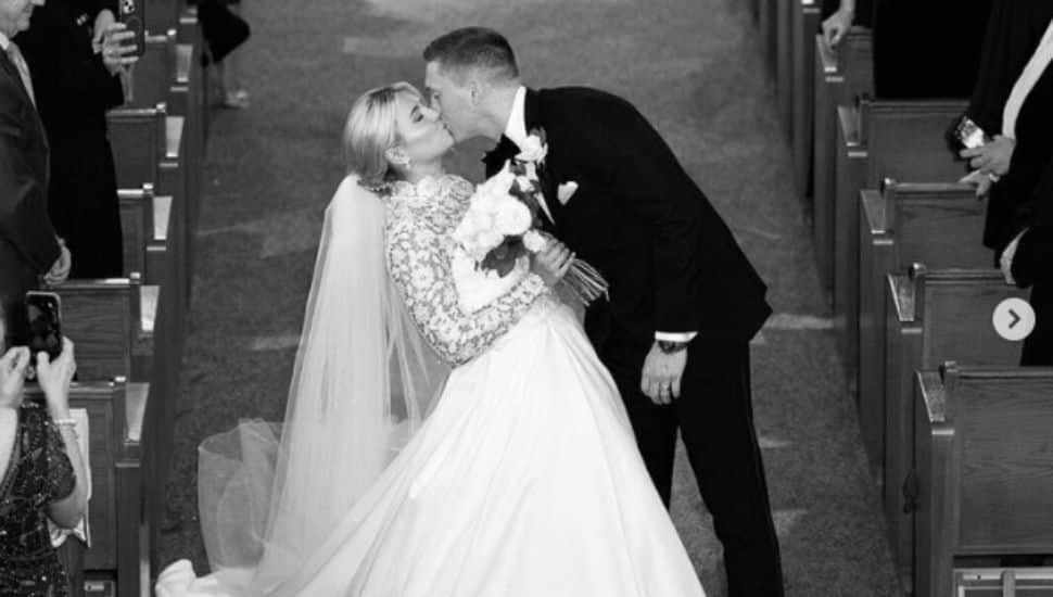 Megan McLaughlin and Ryan Coonahan kissing on wedding day.